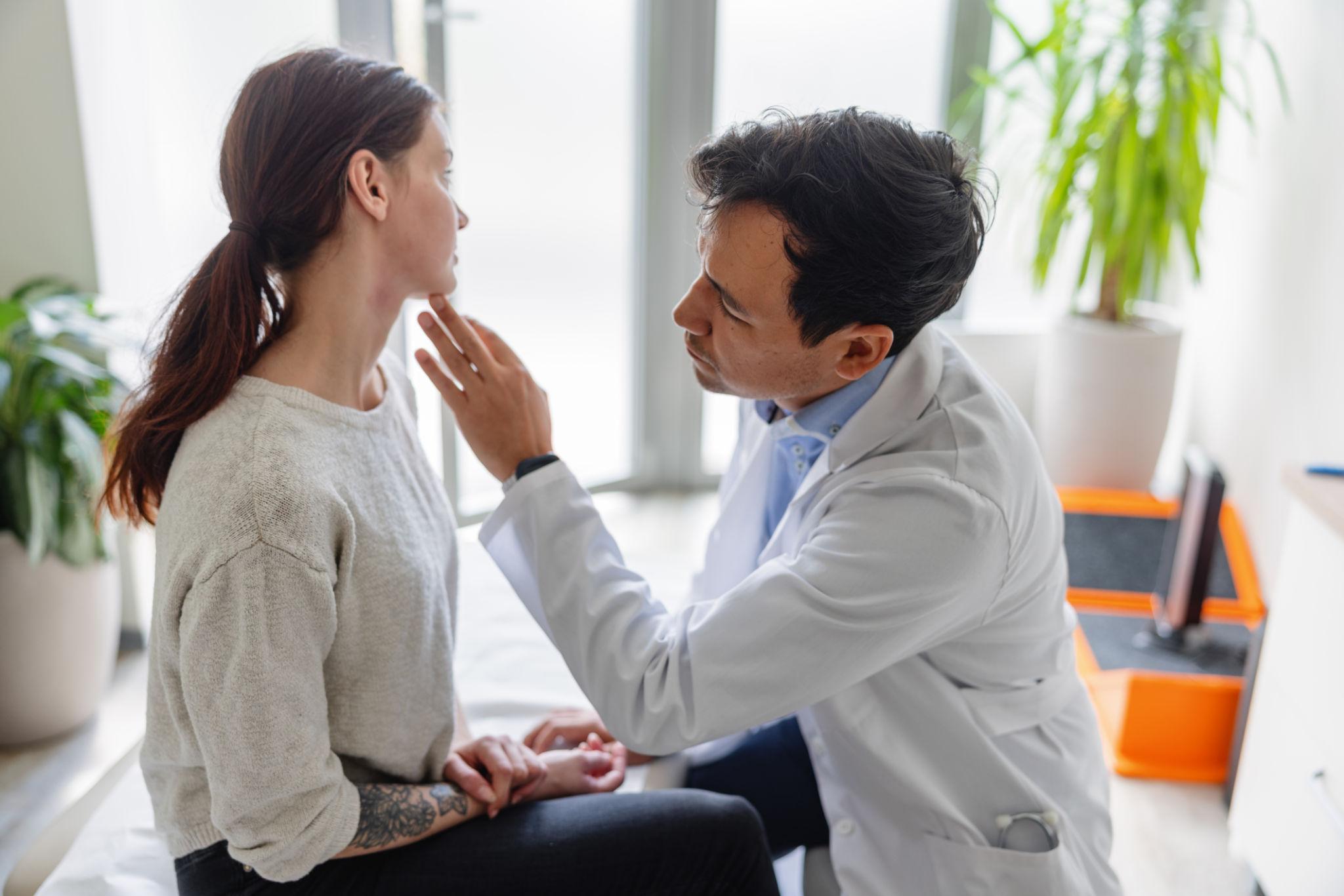 Dermatologist examining a patient for skin signs of internal disease